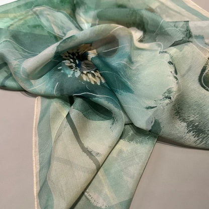 Flowing green floral silk scarf in motion, plant-dyed mulberry silk with soft drape and sheen