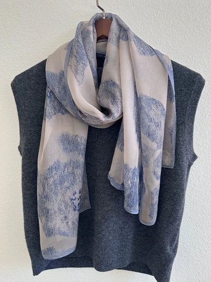 Lightweight plant-dyed mulberry silk scarf with blue vintage ink pattern displayed on fabric