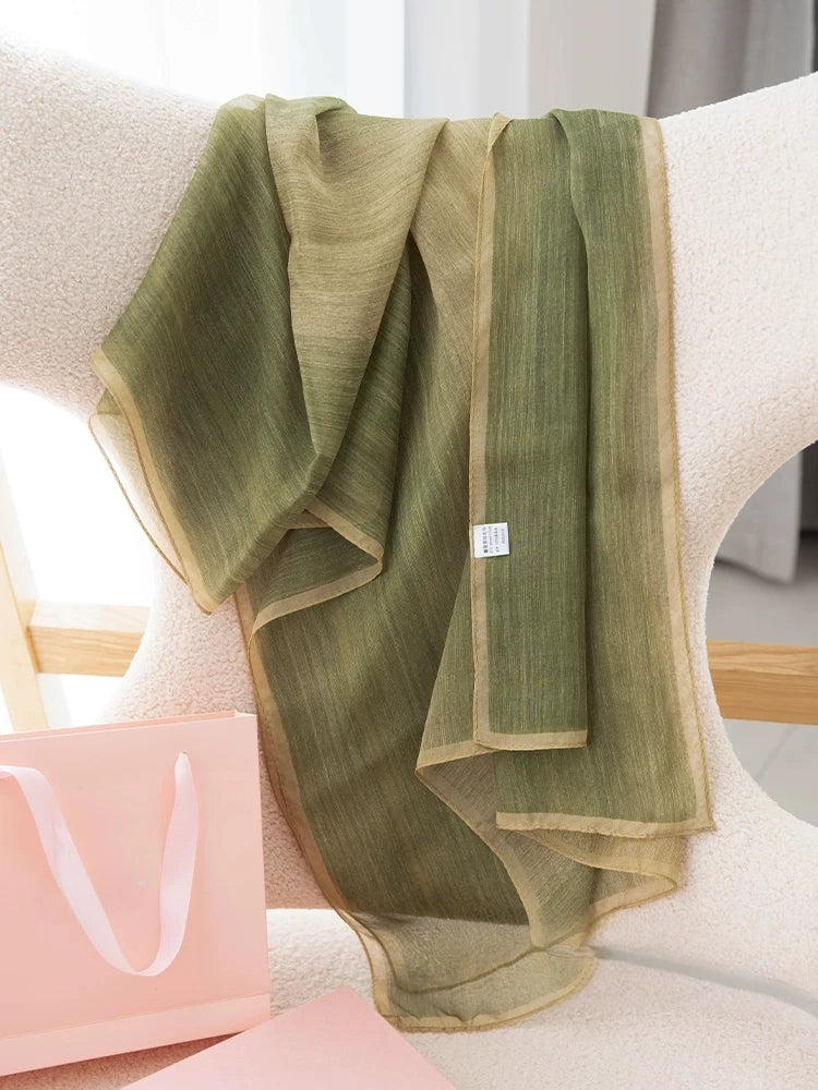 Light green mulberry silk chiffon scarf displayed to show sheer texture and tonal gradient