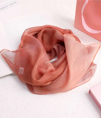 Rose plant-dyed mulberry silk chiffon scarf arranged in a soft draped style