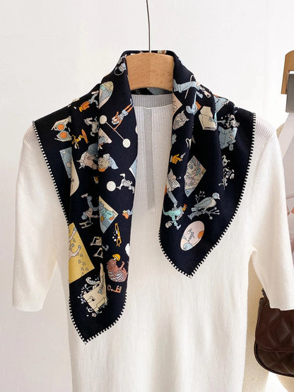 Playful cartoon print silk wool scarf draped loosely over a minimalist white top
