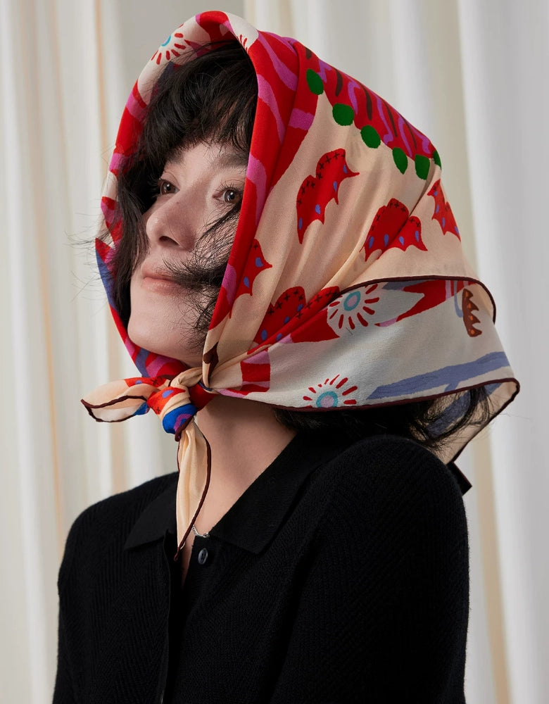 Side view of a woman styling the colorful lion print silk square scarf as a headscarf