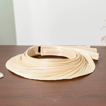 Pleated Buntal straw open top sun hat with extendable brim and natural woven texture.