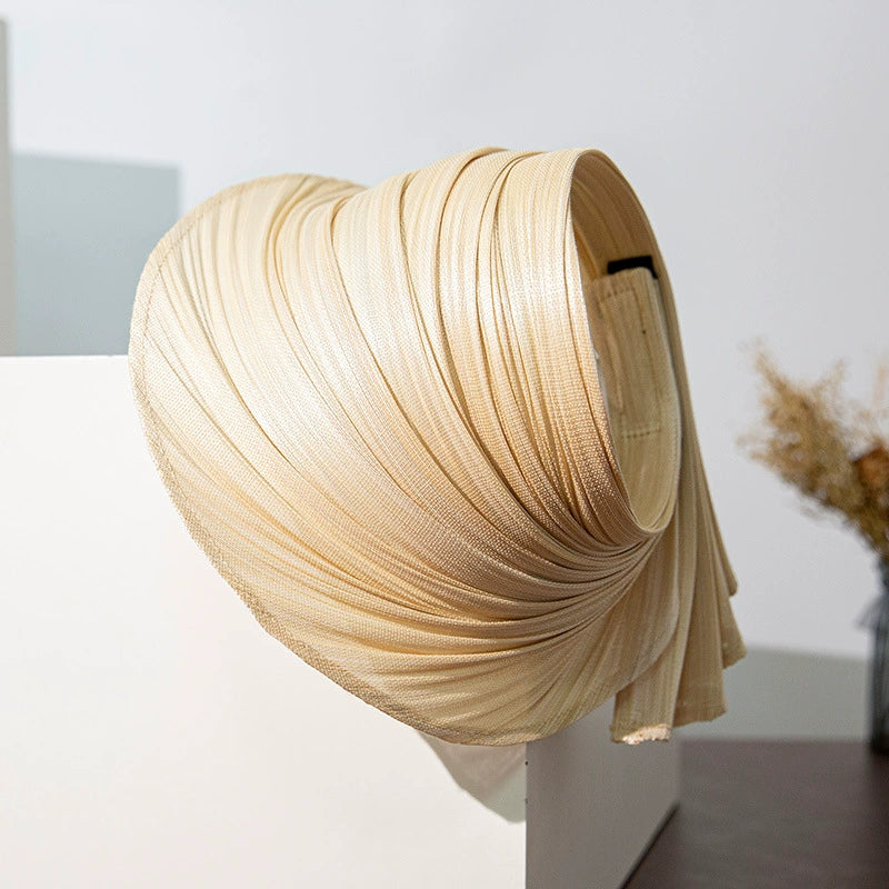Natural Buntal straw sun hat with pleated open top design and adjustable hook-and-loop strap.