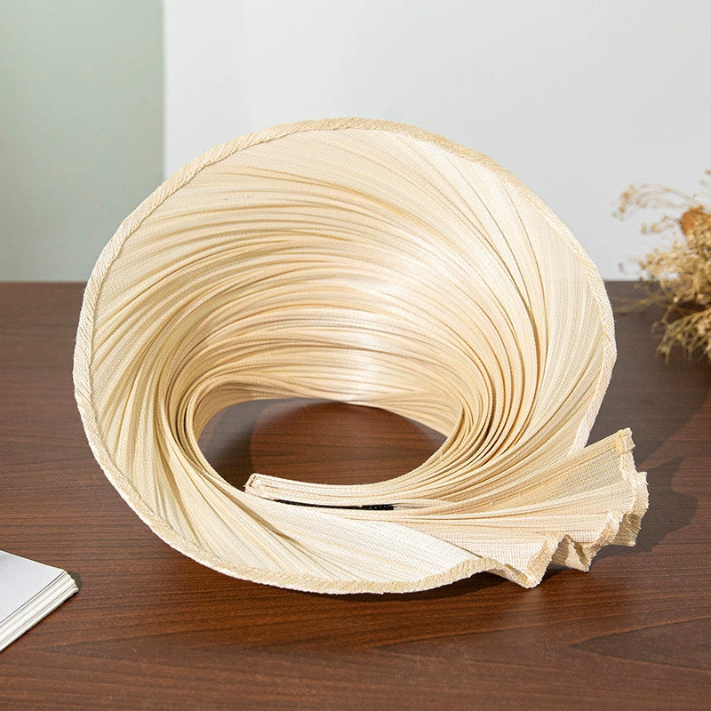 Top view of pleated Buntal straw open top sun hat with extendable brim in natural color.