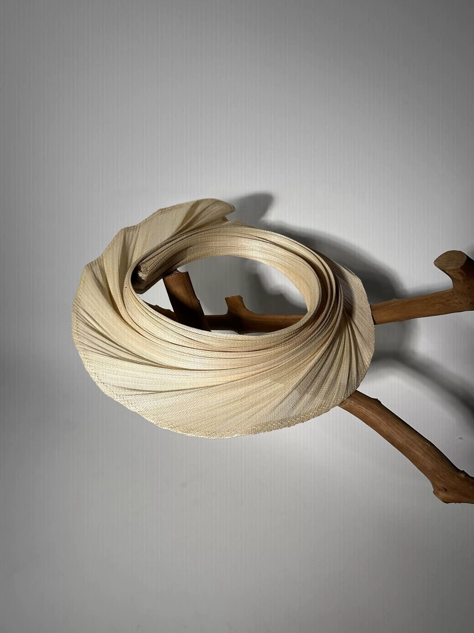 Side view of Buntal straw open top sun hat with extendable brim and lightweight woven design.