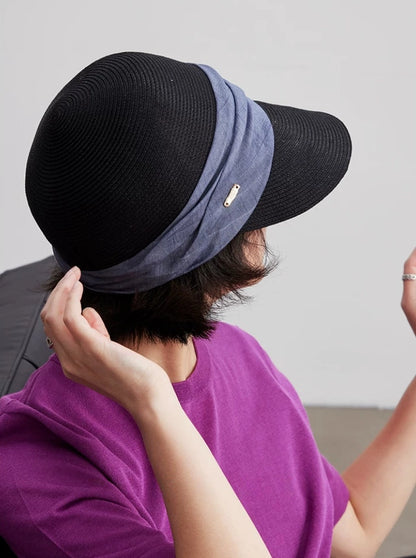 Classic black pleated ribbon visor hat shown from the back with adjustable summer fit