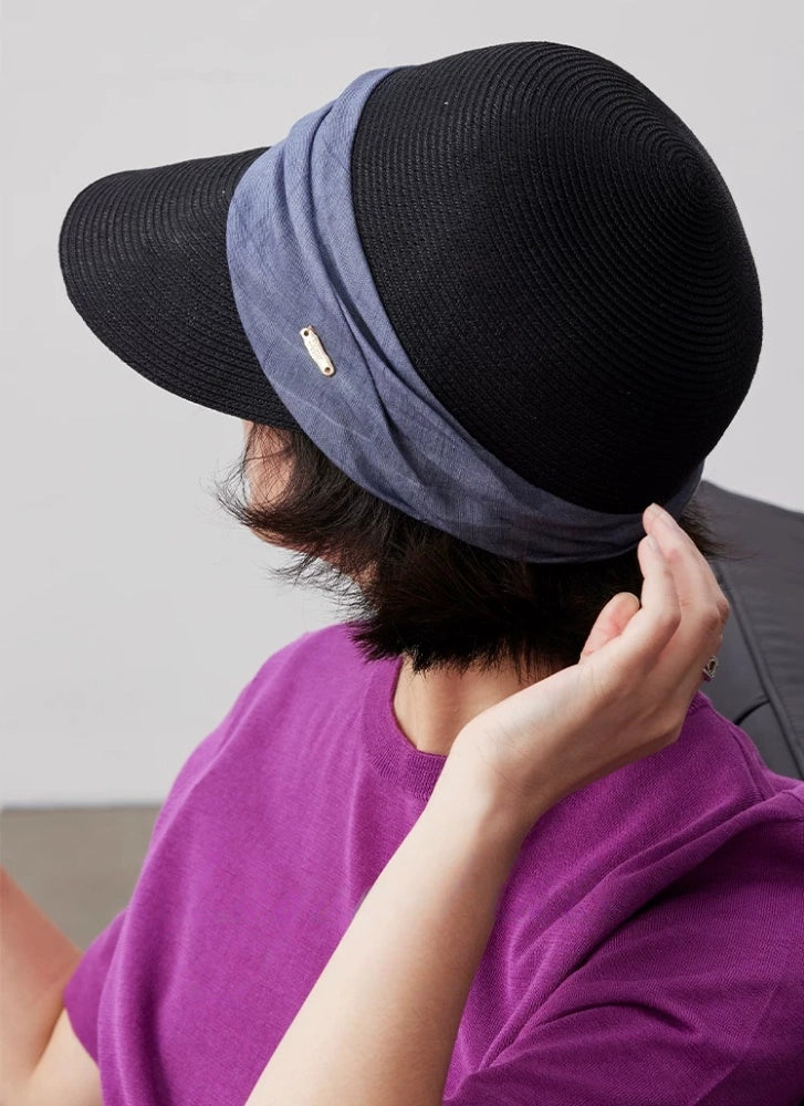 Black sun protection visor hat with blue pleated ribbon detail and breathable open-back design