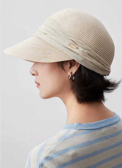 Ivory sun protection visor hat with soft ribbon detail and minimalist side profile