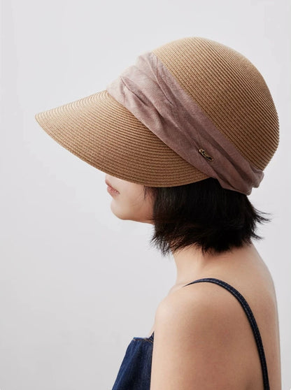 Natural beige beach visor hat with soft ribbon detail for travel and outdoor sun protection