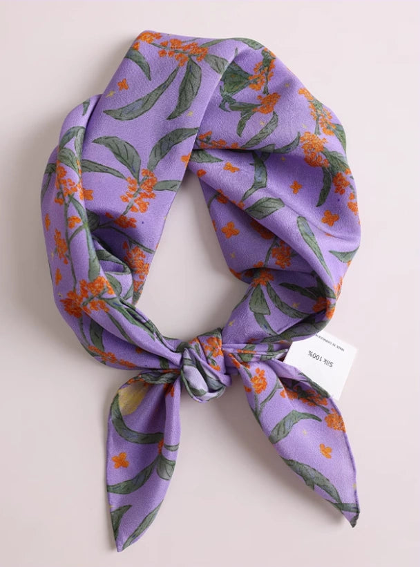 Close-up of purple osmanthus silk scarf, showcasing the delicate floral print and luxurious texture.