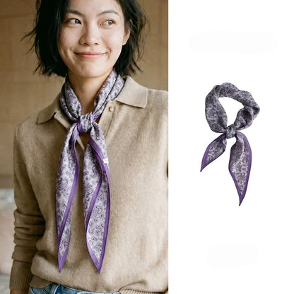 Woman wearing a purple paisley silk wool diamond scarf with a beige knit top