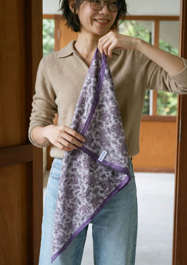 Woman displaying the full length of a purple paisley silk wool diamond scarf