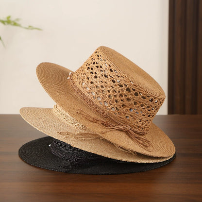 Beige, bronze, and black raffia straw boater hats with hollow open weave design.