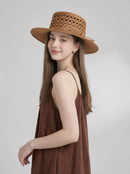 Side view of model wearing bronze raffia straw boater hat for summer styling.