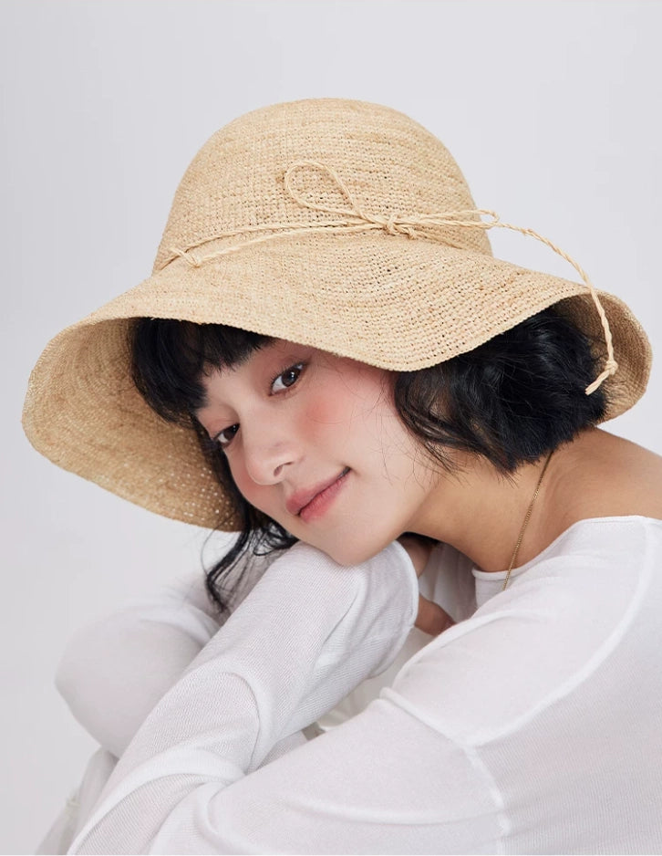 raffia wide brim sun hat close up soft natural straw texture elegant style