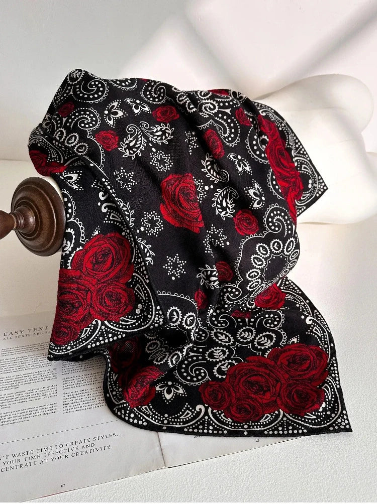 Black vintage rose paisley scarf styled on bag for chic outfit