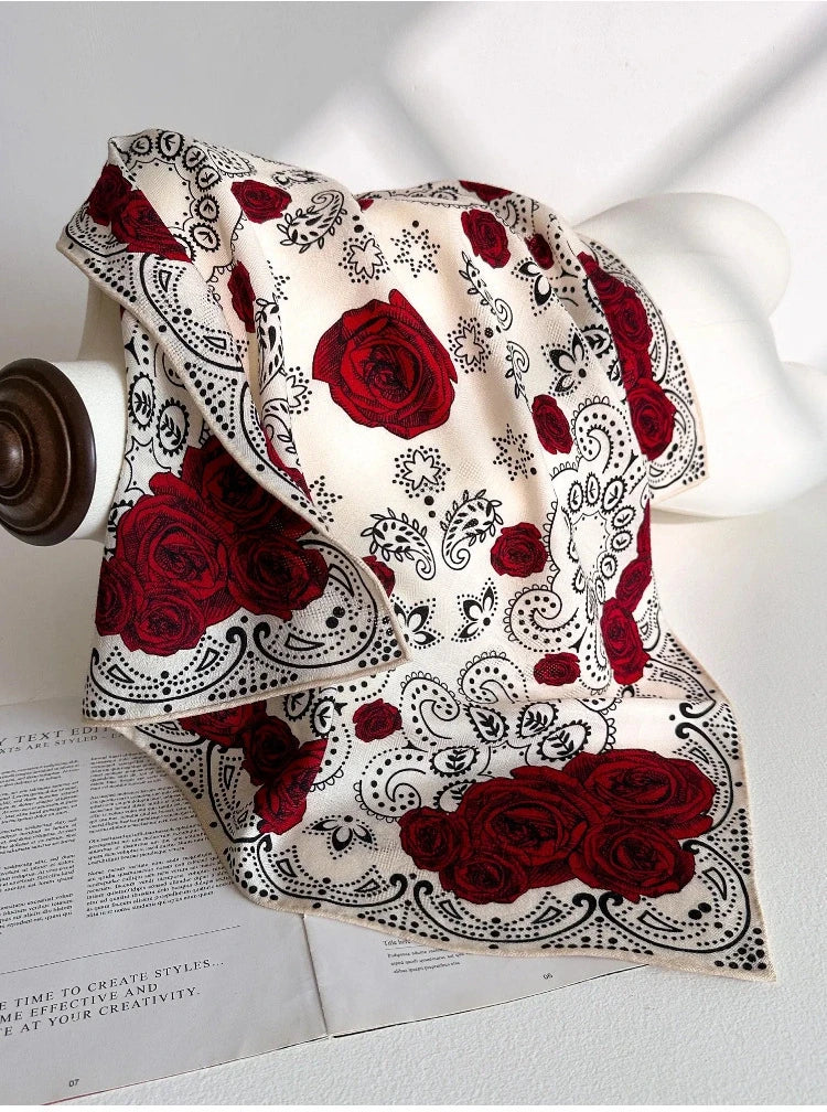 White rose paisley scarf styled on handbag for refined outfit