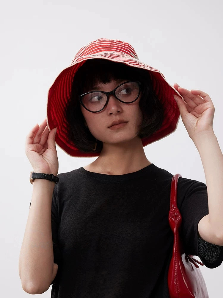 Front view of a red and white striped wide brim sun hat with a soft flexible brim.