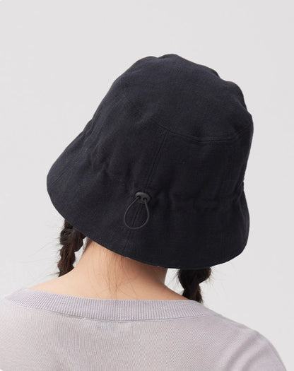 Back view of a black navy cotton linen bucket hat showing the adjustable drawstring detail