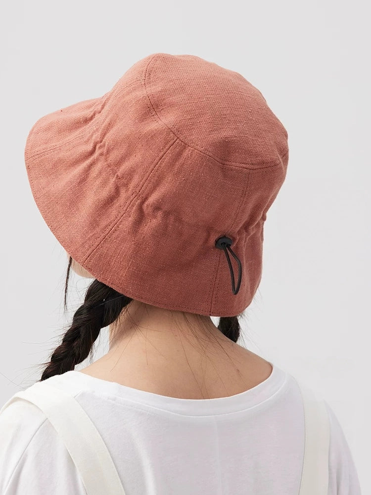 Back view of an orange pink cotton linen bucket hat showing the adjustable drawstring detail