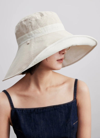 Side view of ivory cotton linen sun hat with full coverage brim and chin strap
