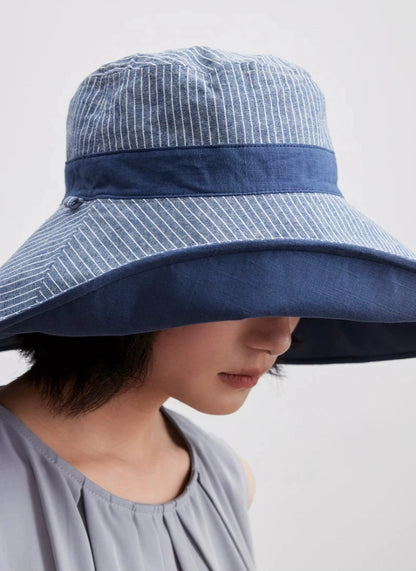 Close-up of smoky blue wide brim sun hat with breathable cotton linen texture