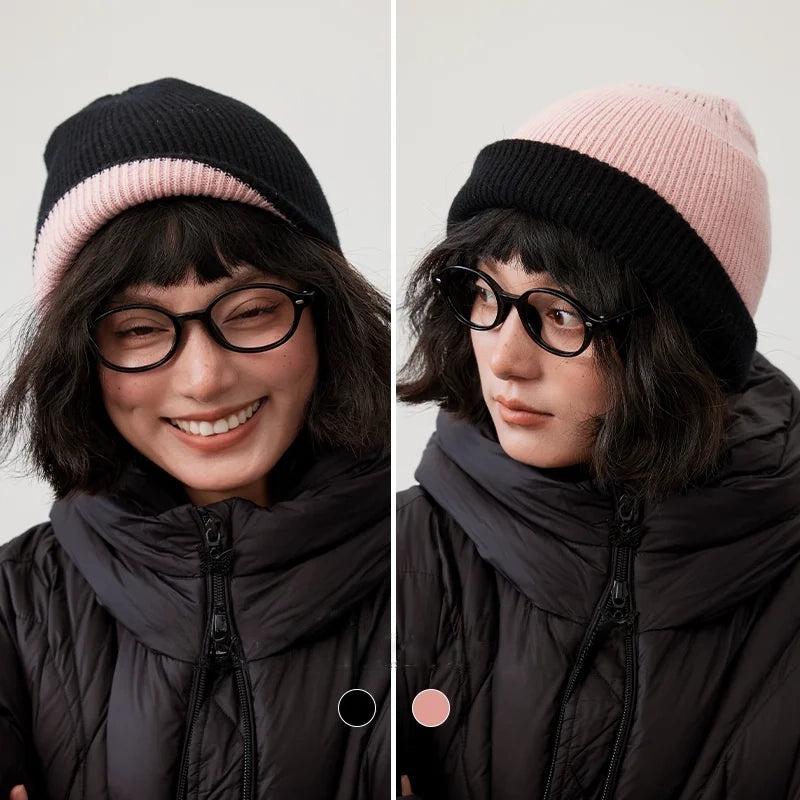 Black and cherry blossom pink reversible wool beanie modeled with each side facing outward.