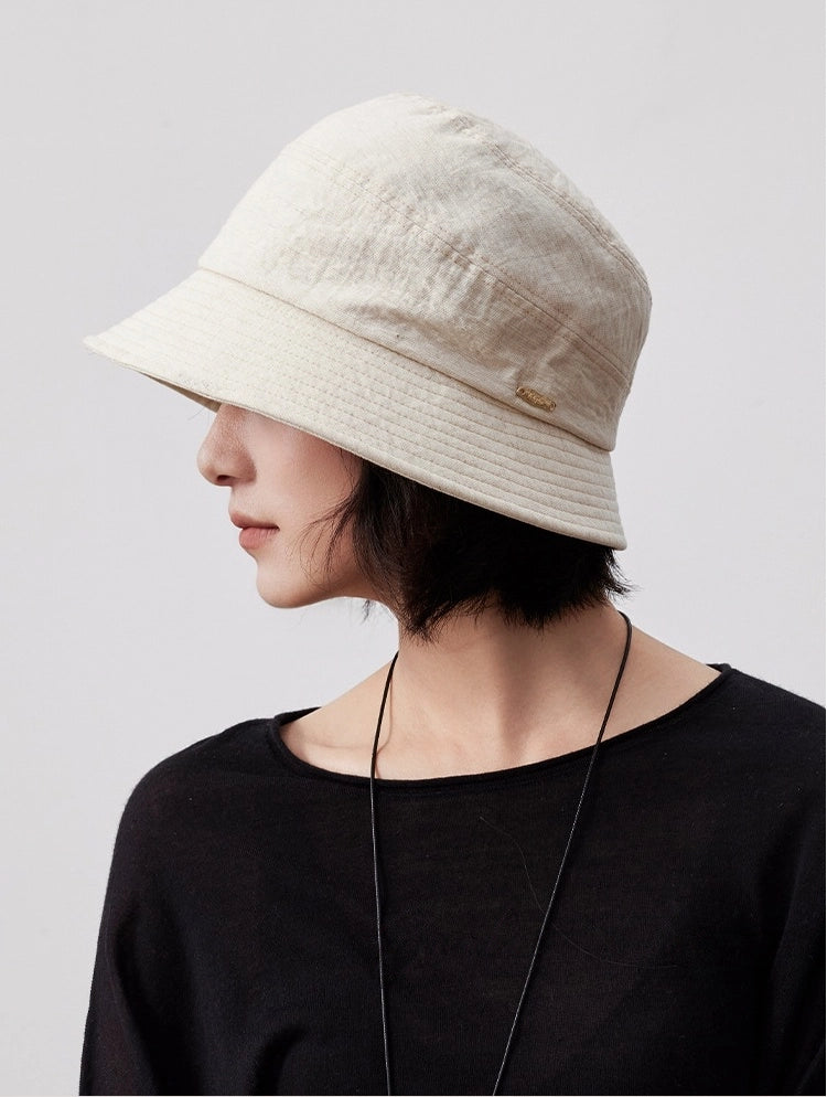 Off white short brim bucket hat lifestyle side view, breathable women's summer bucket hat