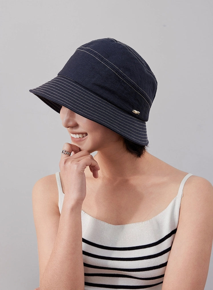 Denim blue short brim bucket hat side angle on model, casual foldable travel hat
