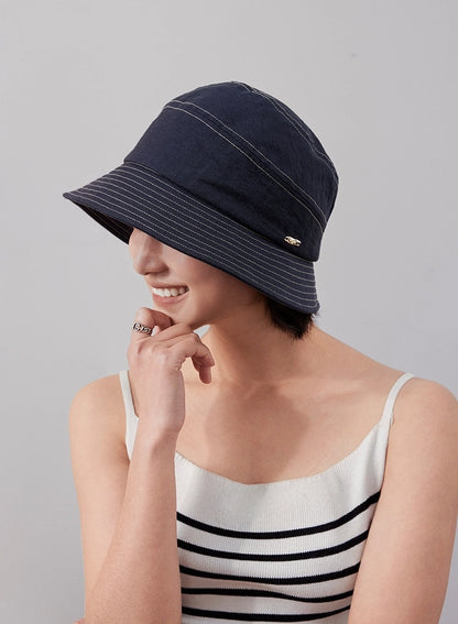 Denim blue short brim bucket hat side angle on model, casual foldable travel hat