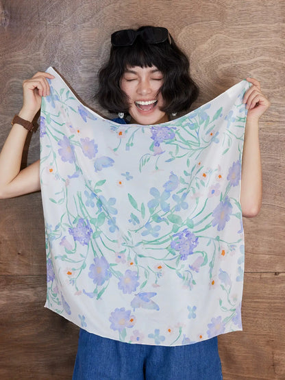 Watercolor floral silk square scarf displayed open to show delicate pastel botanical pattern