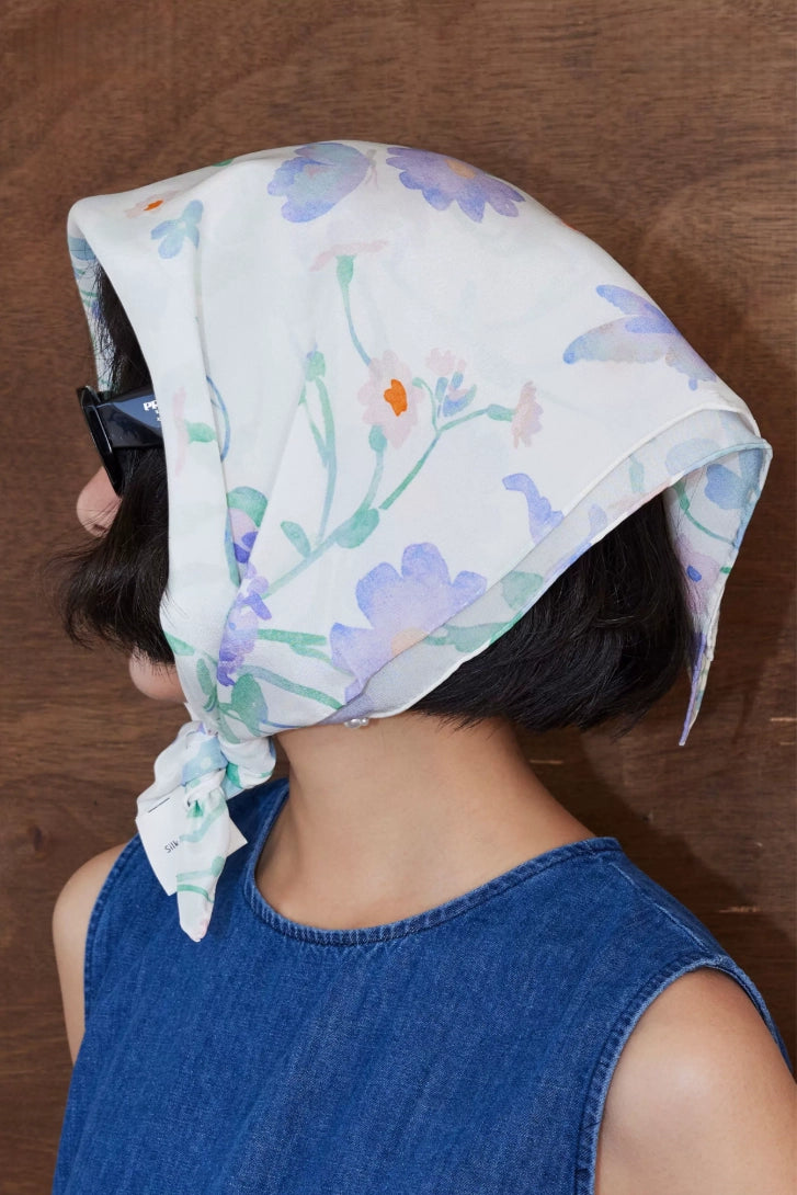 Watercolor floral silk square scarf tied as a headscarf with soft feminine styling