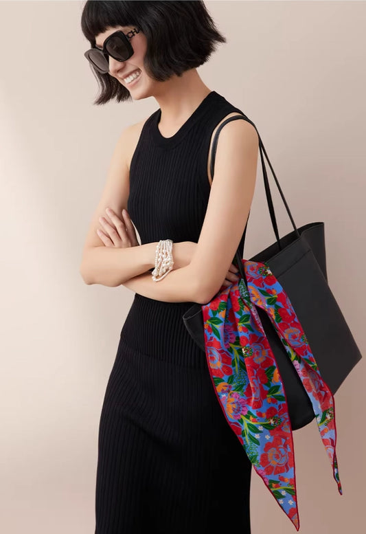 floral silk triangle scarf styled with black dress and tote bag