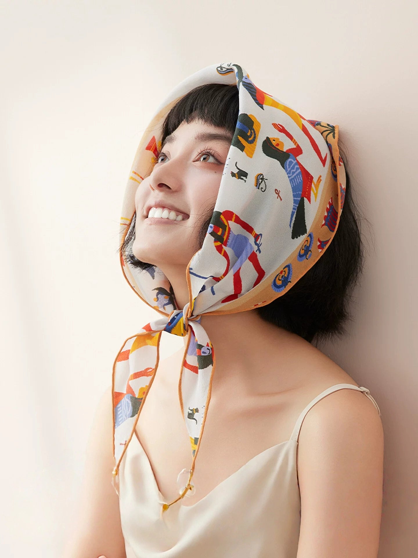 Silk triangle scarf styled as a summer headscarf with sunglasses and sleeveless top