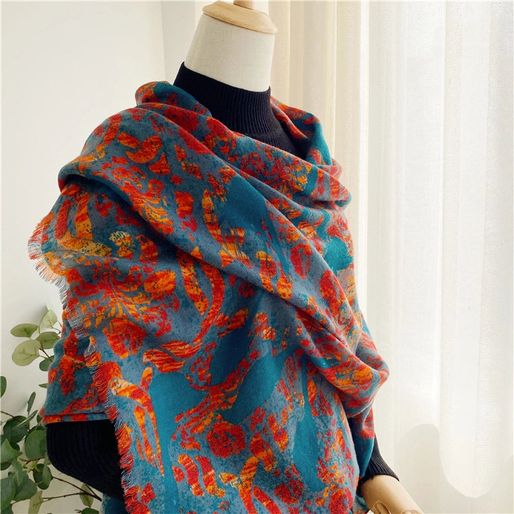 Lightweight teal and flame red wool shawl styled in a loose layered wrap on a mannequin