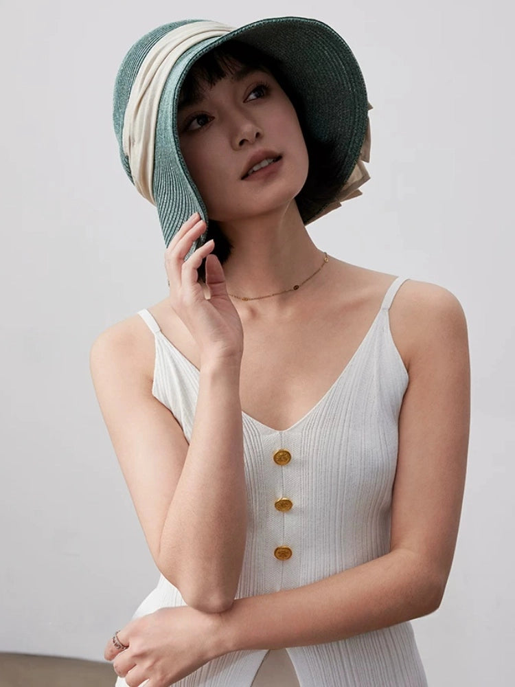 Turquoise green straw sun hat with wide brim and breathable paper straw texture, styled for elegant summer wear.