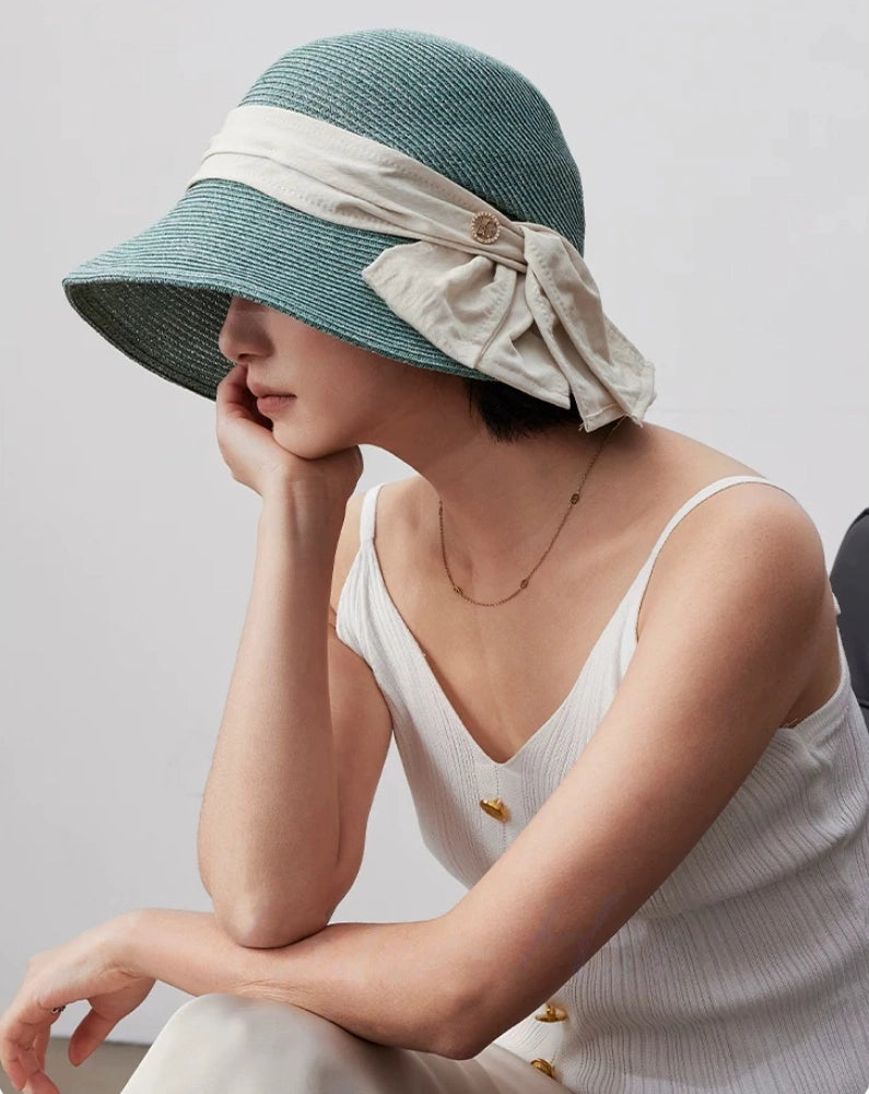 Turquoise green wide brim sun hat with white bow ribbon, designed for beach trips, travel and daily sun protection.