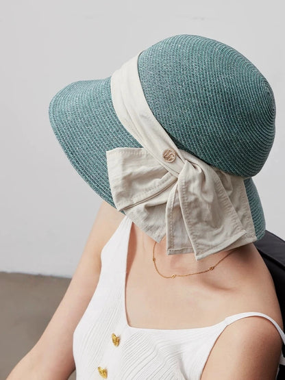 Turquoise green straw sun hat with back bow ribbon detail, ideal for resort styling, vacations and outdoor summer looks.