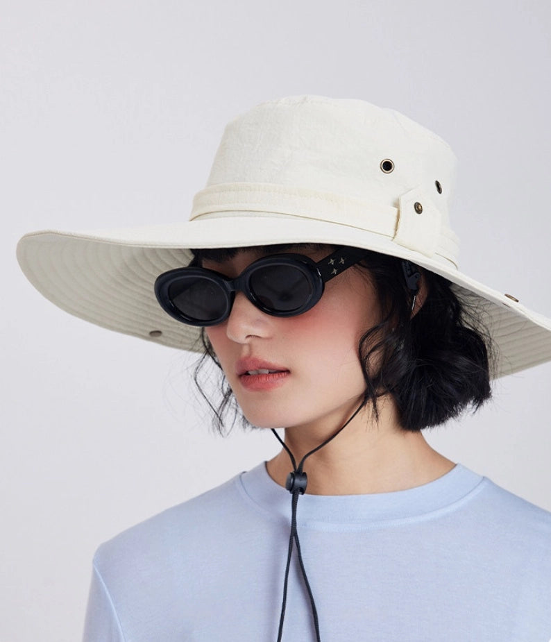 Off white UV protection sun hat with sunglasses, wide brim, and outdoor travel style