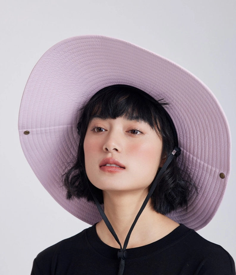 Pink extra wide brim sun hat with adjustable chin cord and foldable outdoor design