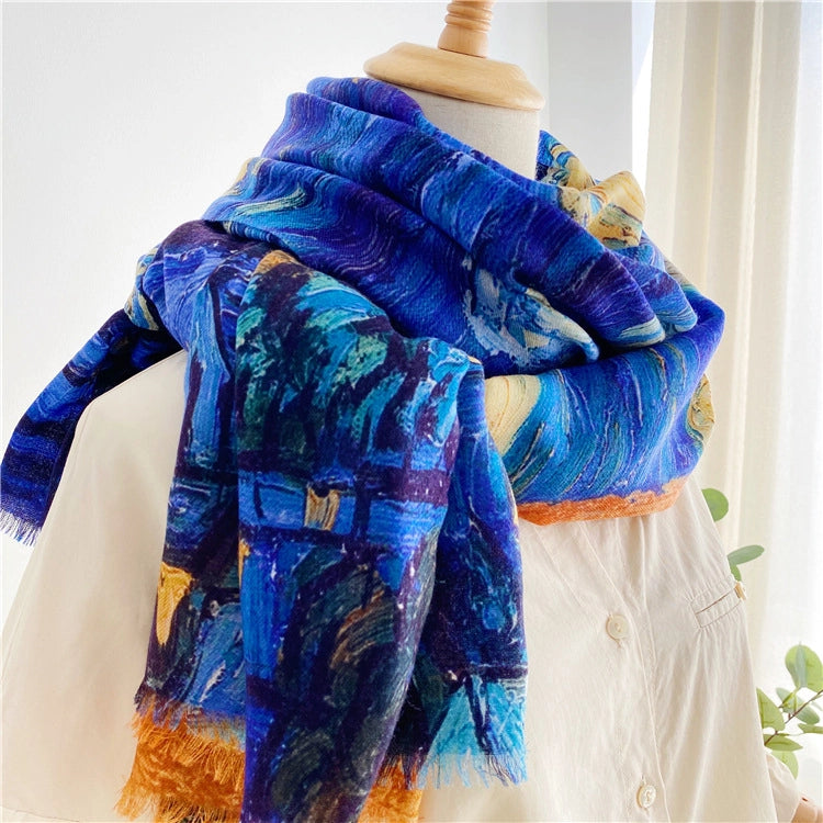Oversized Van Gogh art scarf layered around the shoulders with a cobalt blue print and orange fringe