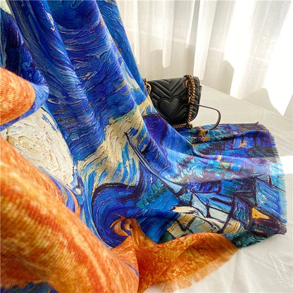 Large Starry Night wool scarf draped beside a black handbag, highlighting its fluid blue and orange art print