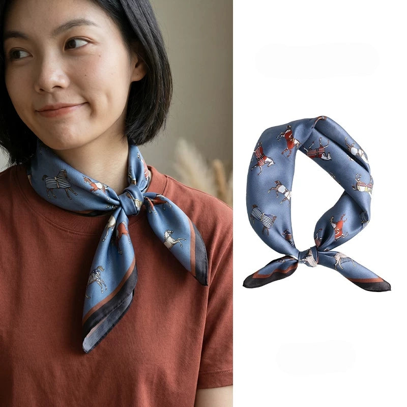 Vintage blue horse print mulberry silk scarf styled around the neck with a side knot