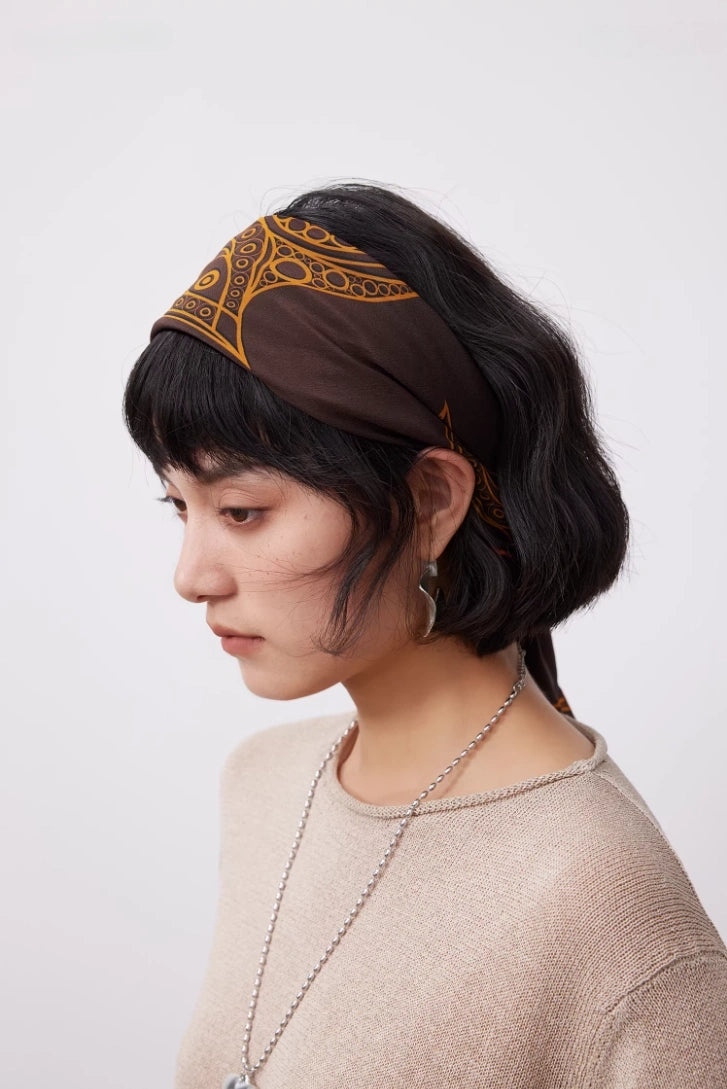 Vintage brown mulberry silk square scarf styled as a silk headband for an artistic hair accessory look.