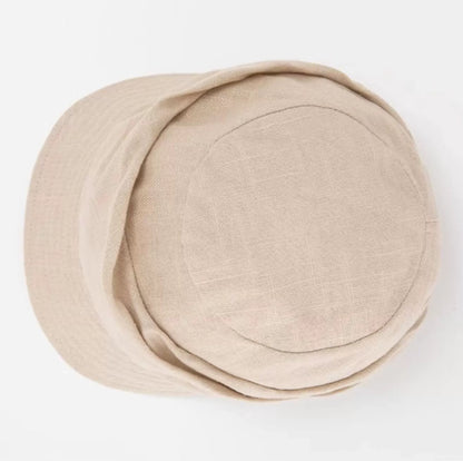 Top view of cream white cotton linen beret newsboy cap with soft round crown