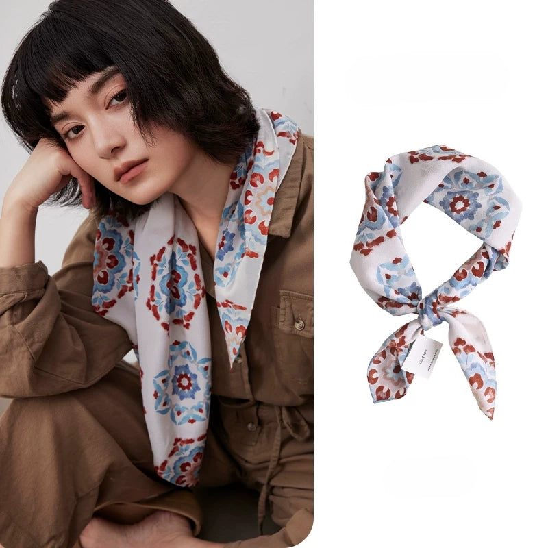 Vintage floral geometric silk square scarf in 100% mulberry silk styled on a model with matching scarf detail.