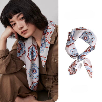 Vintage floral geometric silk square scarf in 100% mulberry silk styled on a model with matching scarf detail.