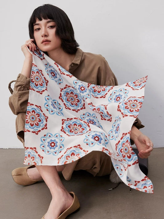 Blue vintage floral geometric silk square scarf made from 100% mulberry silk, shown as an elegant fashion accessory.