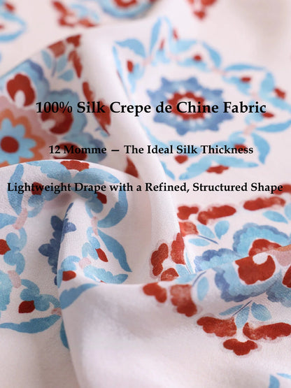 Close-up of 100% silk crepe de chine fabric with vintage floral print and soft lightweight drape.